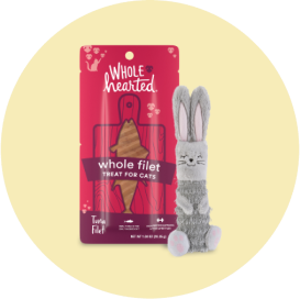 A bag of Whole Hearted cat treats and a gray rabbit toy.