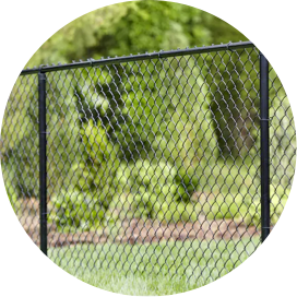 A section of black chain link fencing in a yard.