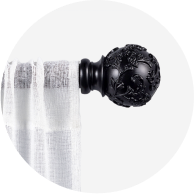A sheer white curtain hanging from a black curtain rod.