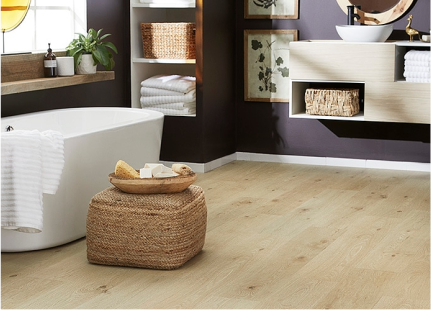 Light wood-look laminate floors in a bathroom with a white stand-alone tub.