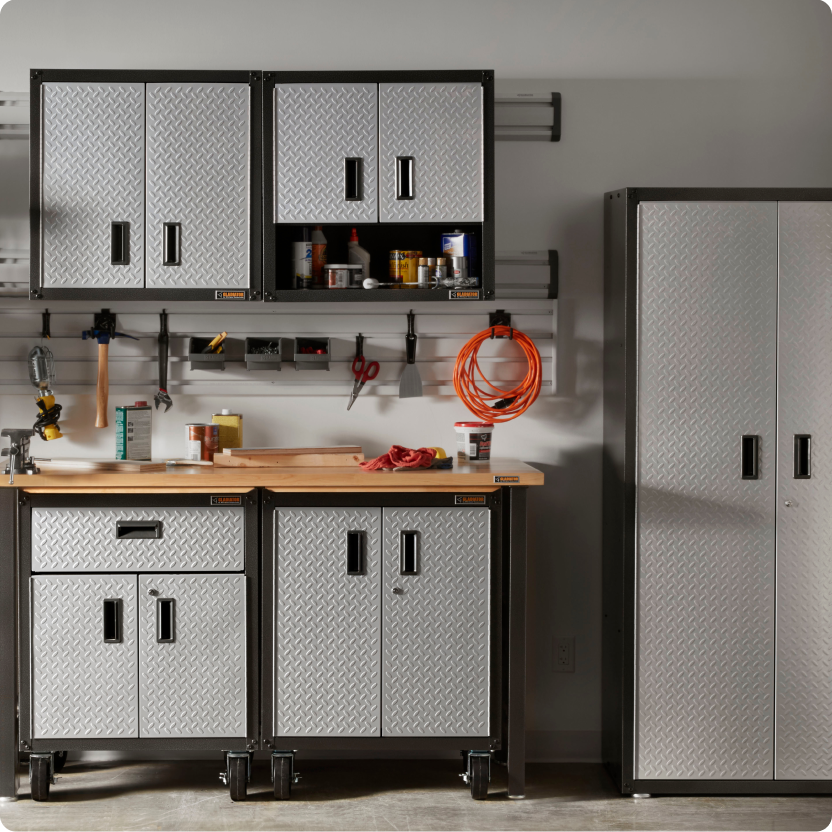 A tall Gladiator garage cabinet, small cabinets under a wood worktop and cabinets on a rail system.