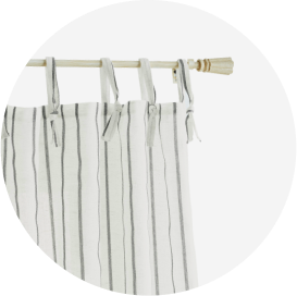 A gray and white striped top-tab curtain on a white rod.