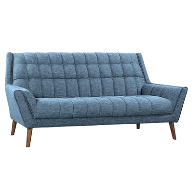 Blue linen sofa with wood legs and tufted background.