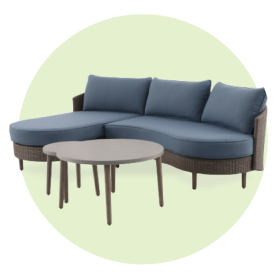 A patio conversation set with blue cushions and coffee table.