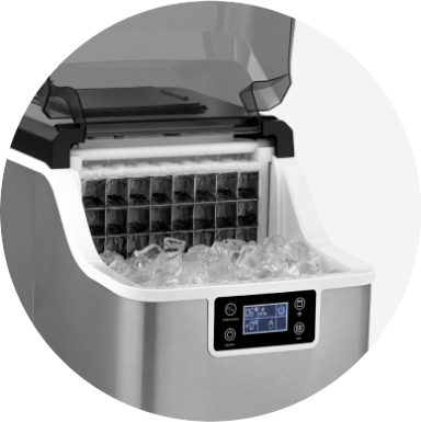 A stainless steel cubed ice maker on a patio table with a gray striped runner.