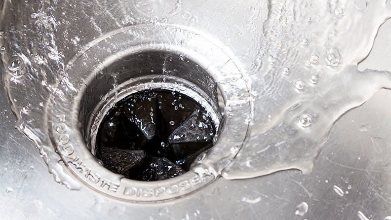 slate grey kitchen sink with garbage disposal button