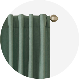 A pale green back-tab curtain on a brushed nickel rod.