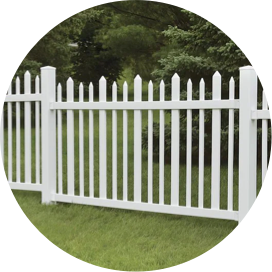 A section of white vinyl fence in a yard.
