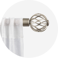 A sheer white curtain hanging from a silver curtain rod. 