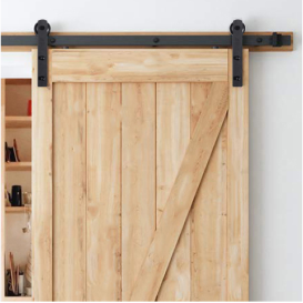 A sliding wood door with matte black hardware. 