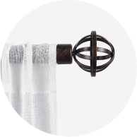 A sheer white curtain hanging from a bronze curtain rod.