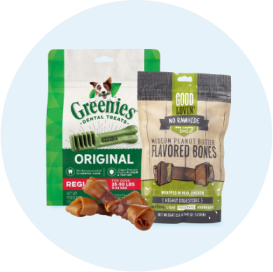 A bag each of Greenies and Good Lovin’ dog treats beside a couple of rawhide bones.
