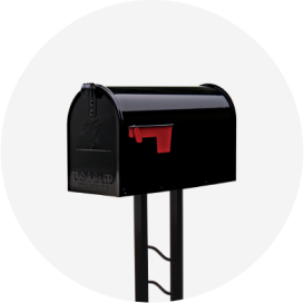 A shiny black mailbox on a metal post with a red flag.