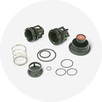A variety of valve parts from a repair kit.