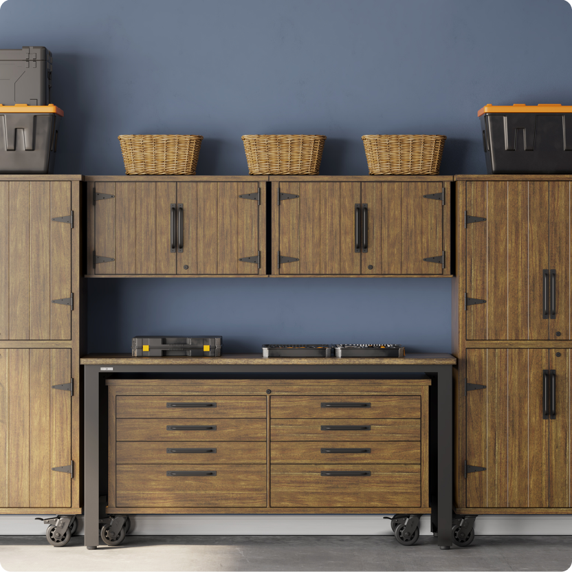 A Scott Living walnut composite wood garage storage system with cabinets, a work bench and drawers.