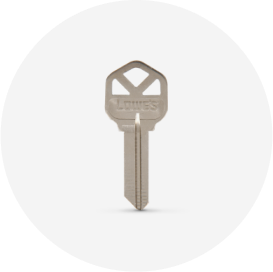 A silver house key with a Lowe’s logo.