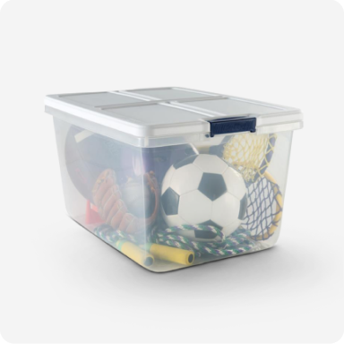 A clear storage tote full of sports equipment.
