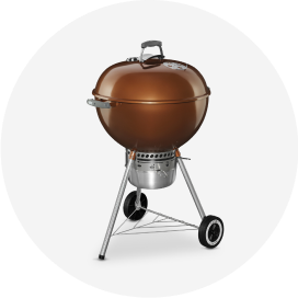 A Weber copper kettle charcoal grill.
