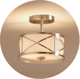 A gold round semi-flush mount light with frosted drum shade.