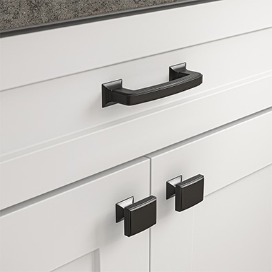 Pewter cabinet hardware on white kitchen cabinets.