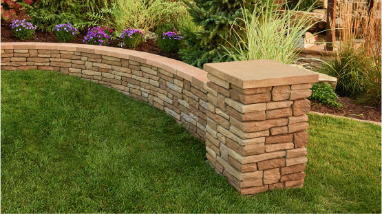 A stacked retaining wall with a capped end post.