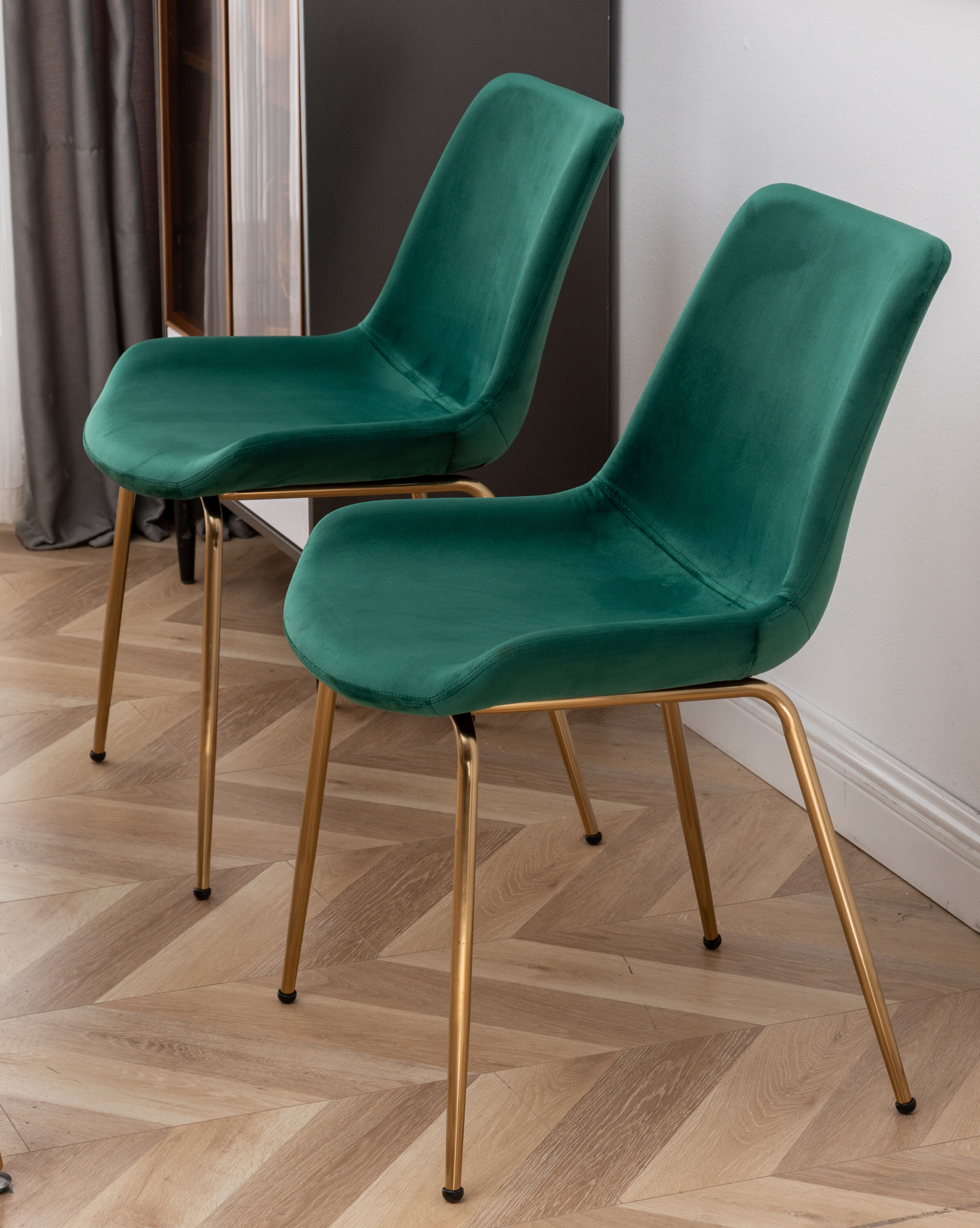 Close-up of green velvet dining chair legs and seat