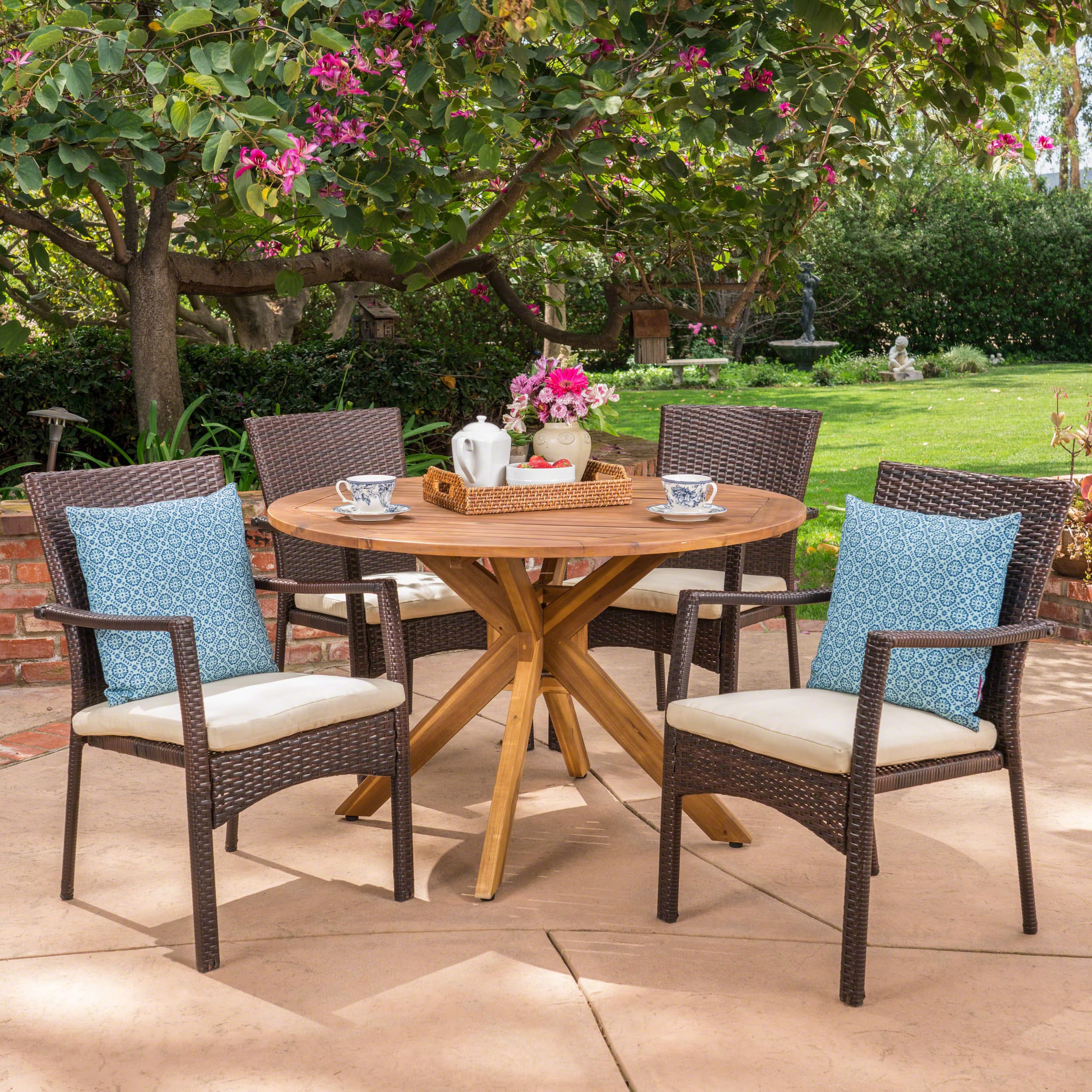 Christopher Knight Home 304076 Stamford Outdoor 5 Piece Brown Wicker Dining Set with Teak Finish Acacia Wood Circular Table and Crème Water Resistant Cushions