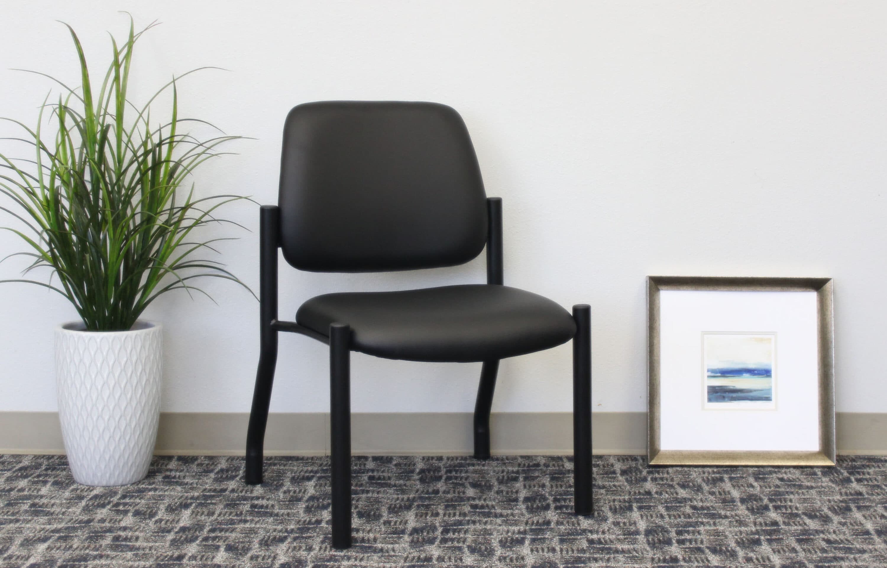Sleek Mid-Back Armless Guest Chair in Antimicrobial Black Vinyl