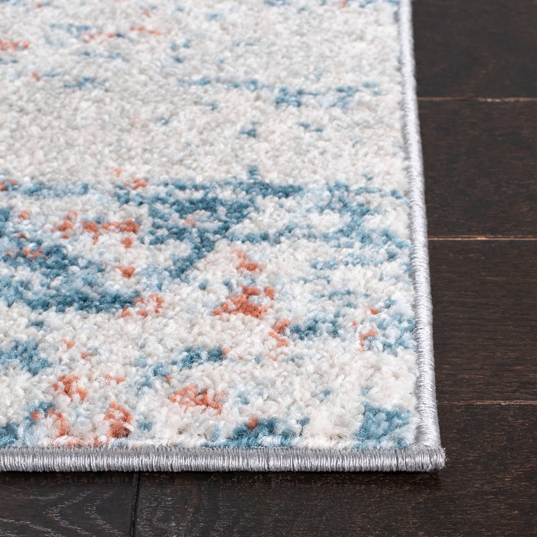 Ivory and Blue Abstract 9' x 12' Stain-Resistant Rug