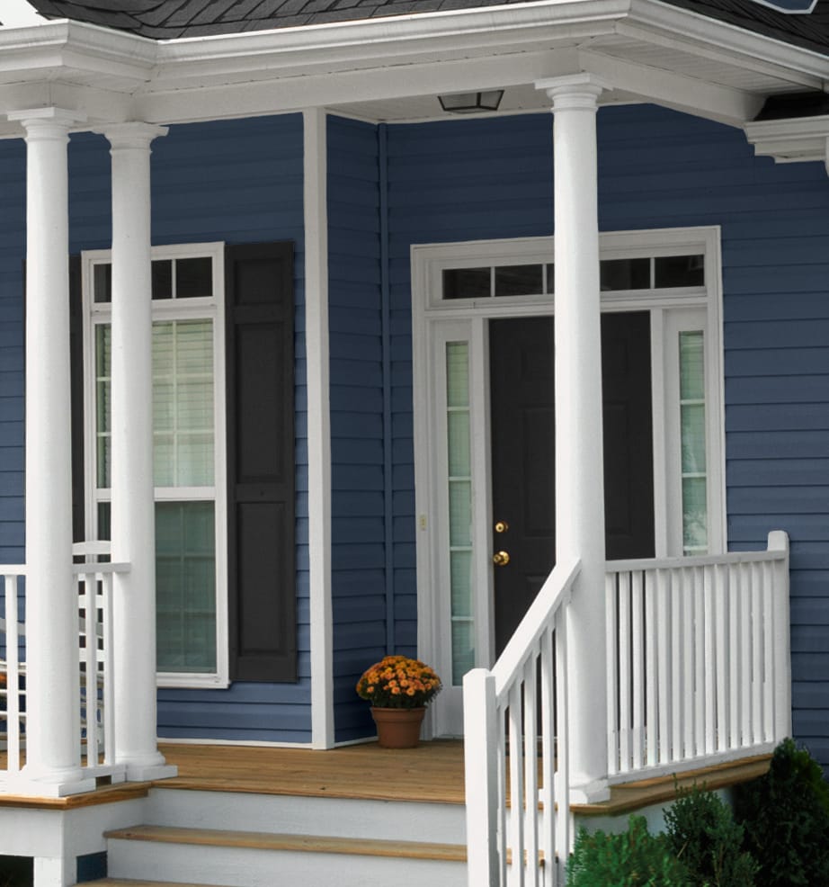 Vinyl Monogram 46 siding - Pacific Blue with a treated deck