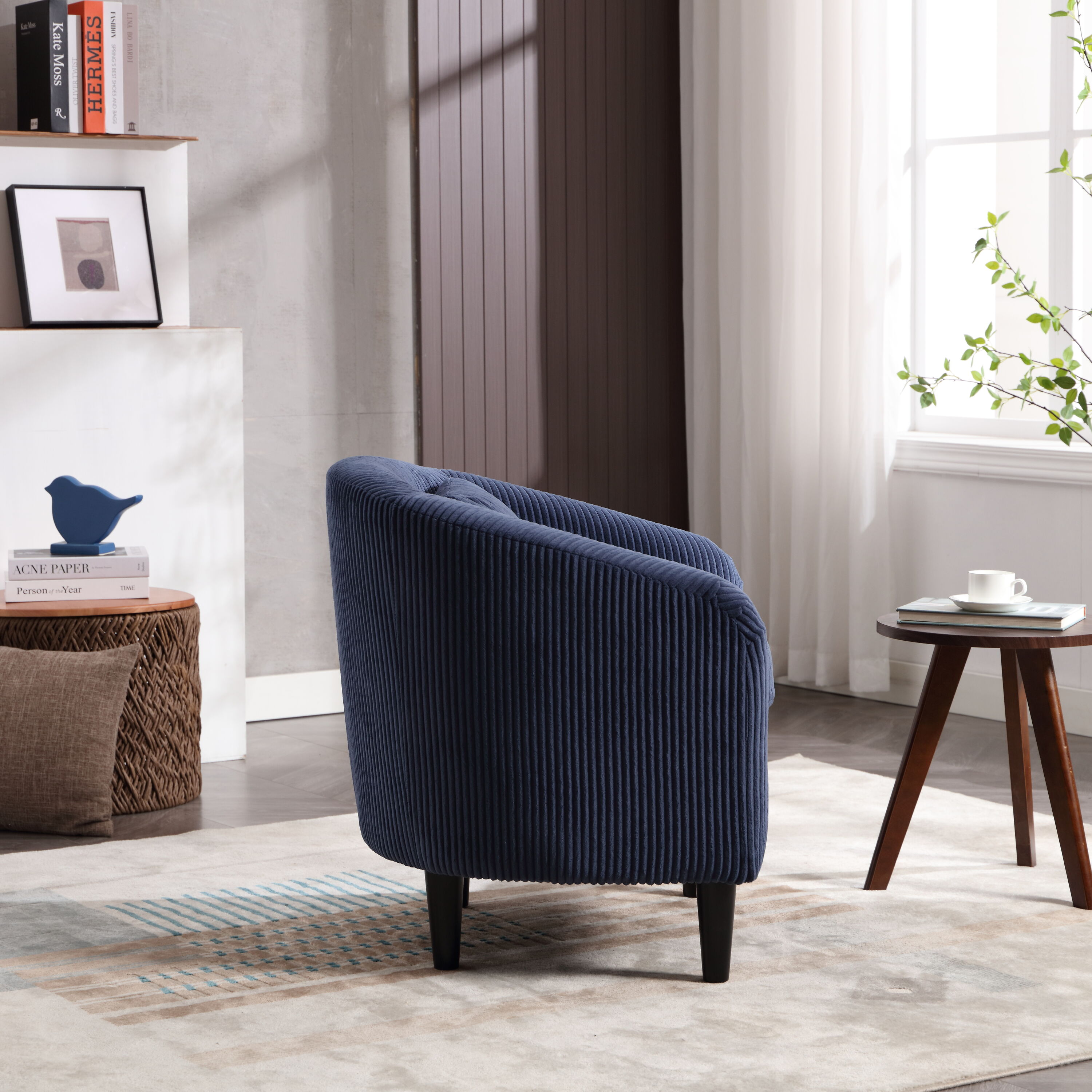 Blue ribbed upholstered armchair with wooden legs in living room