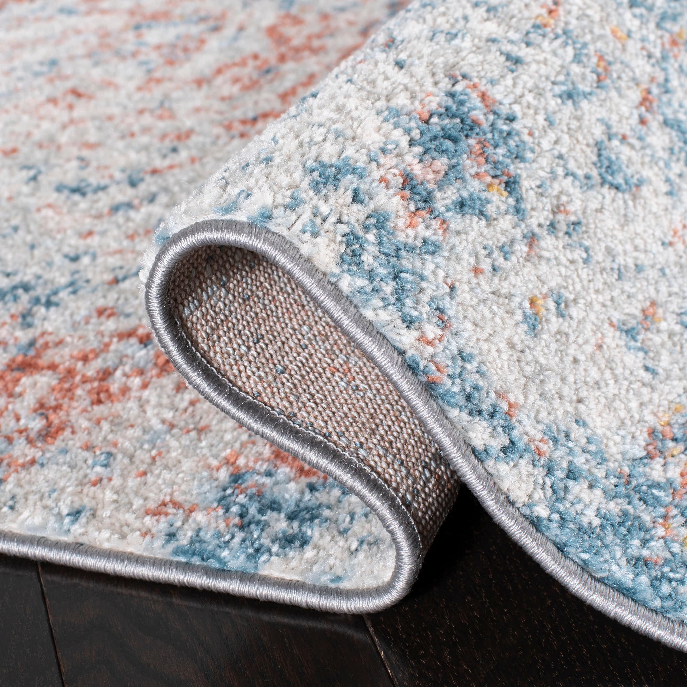 Ivory and Blue Abstract 9' x 12' Stain-Resistant Rug