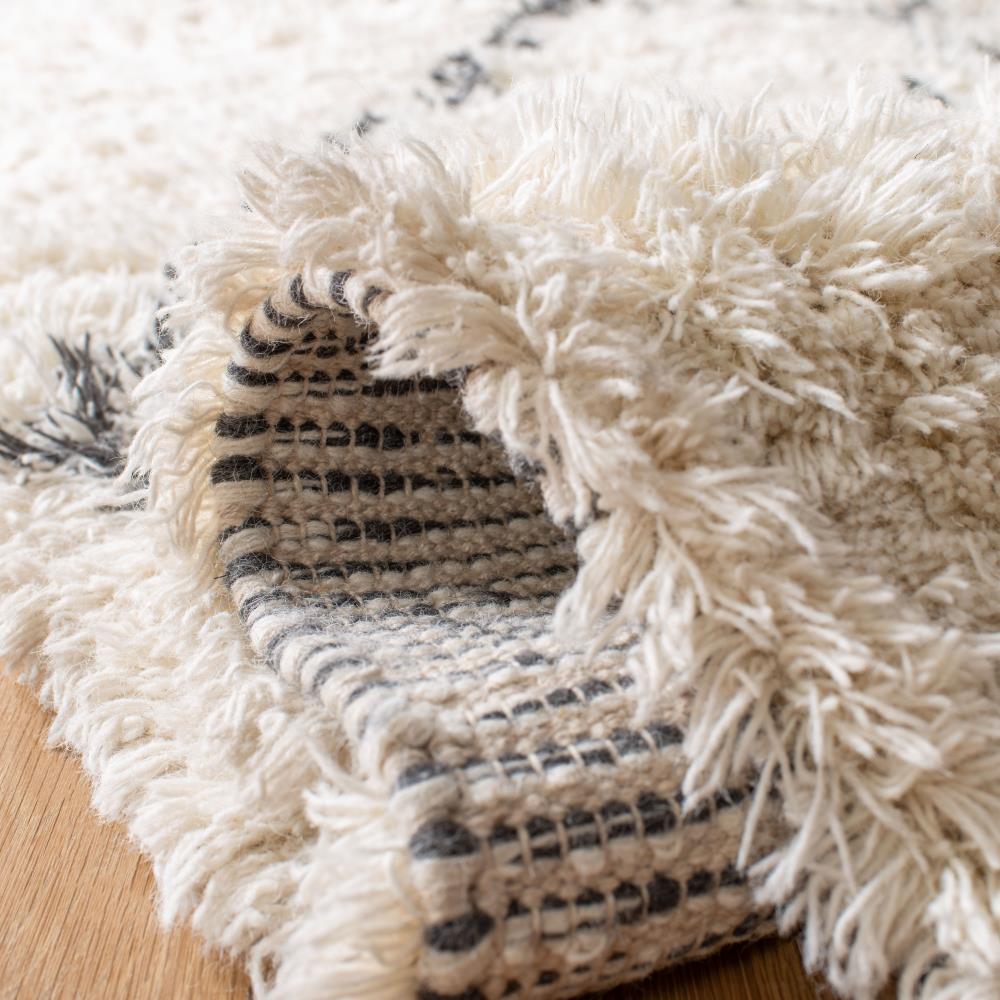 Handmade Ivory Wool Shag 5' x 8' Area Rug with Tasseled Ends