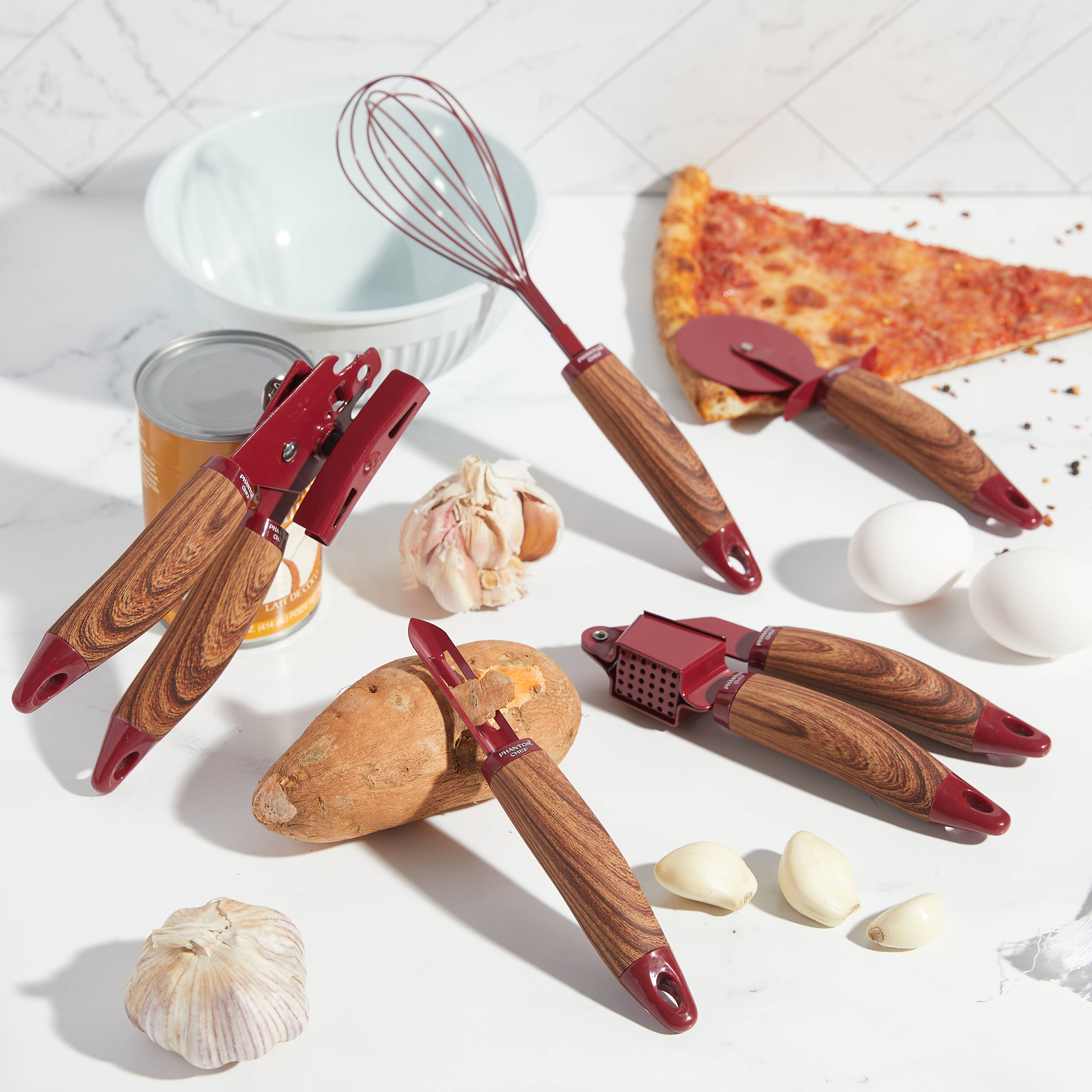 Phantom Chef PC-218-600  five Piece Kitchen Gadget Set. It includes a Pizza Cutter  Whisk  Peeler  Can Opener and Garlic Press.