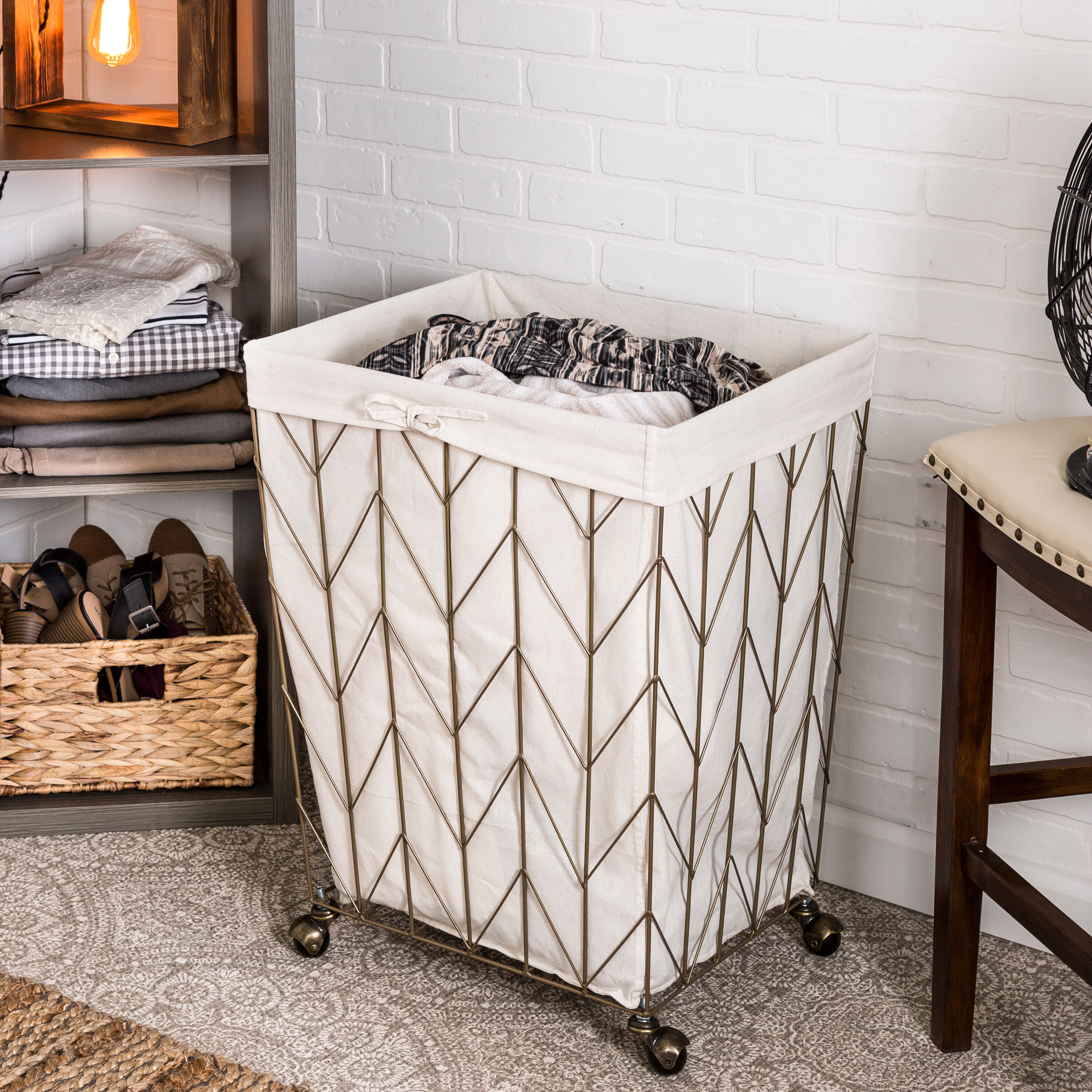 Add wheels to a metal trash can to be used as a clothes hamper