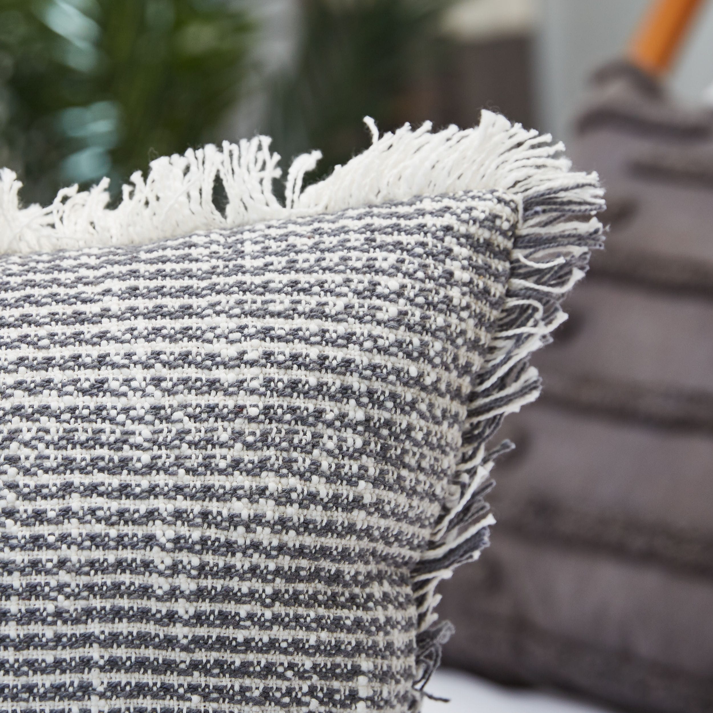 Gray fringe outlet pillow