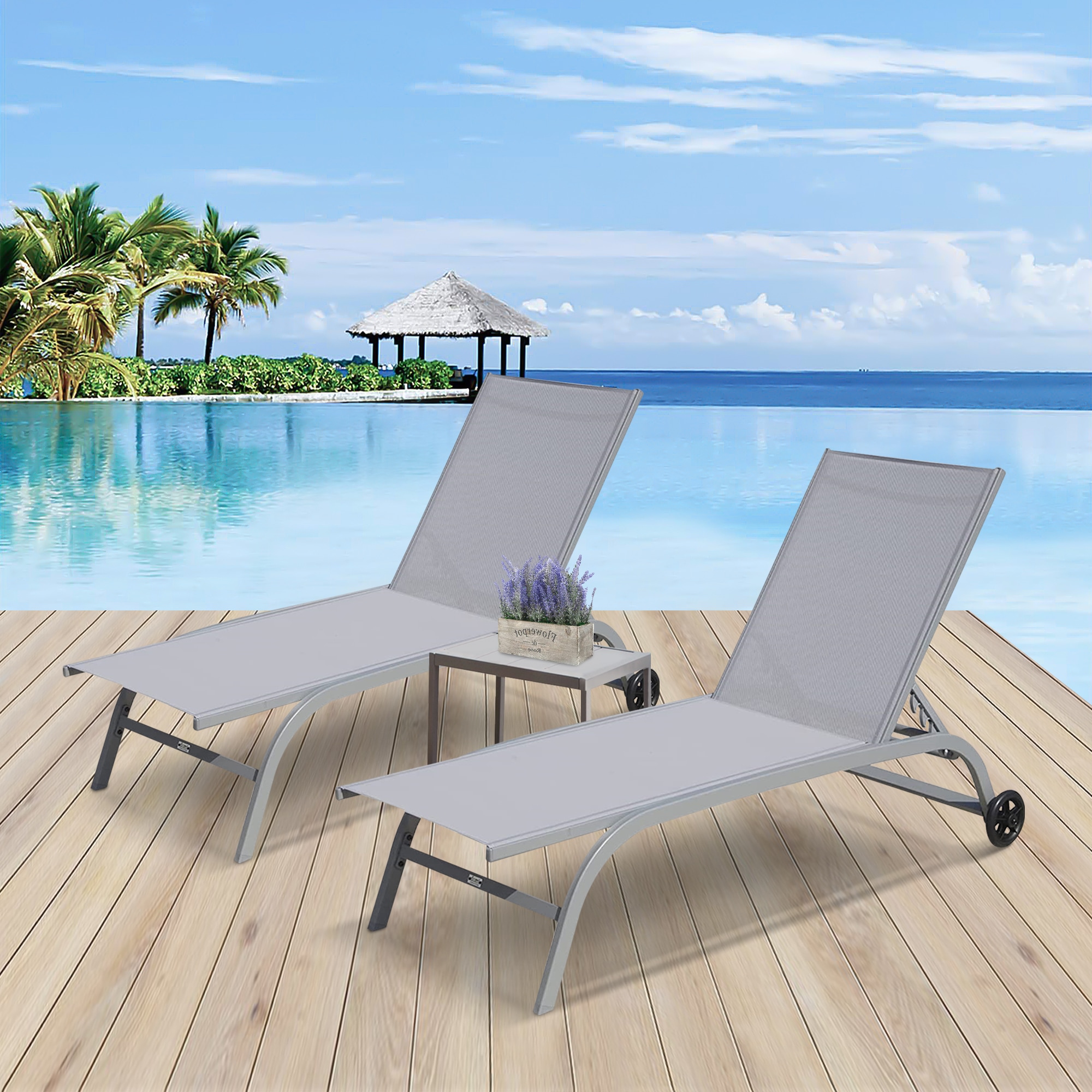 Two grey chaise lounges by ocean on wooden deck