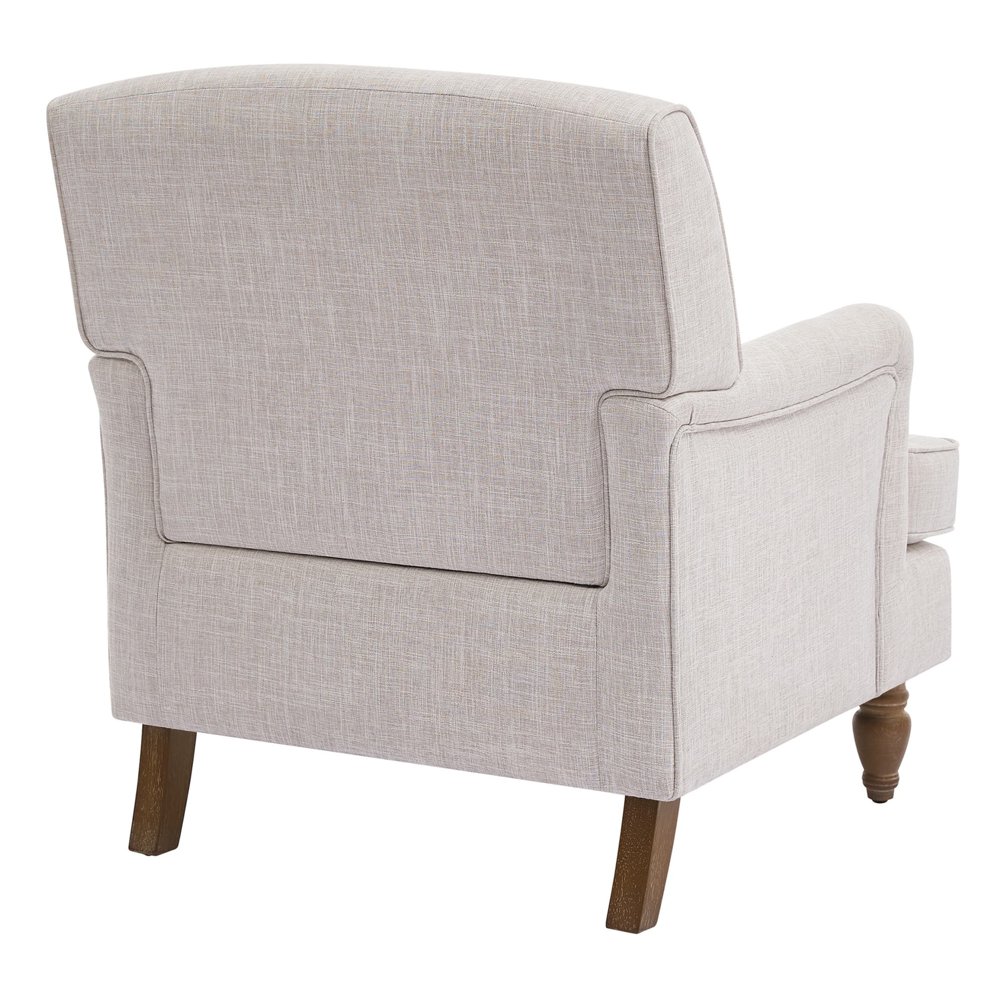 Back view of beige upholstered armchair showing back cushion and legs