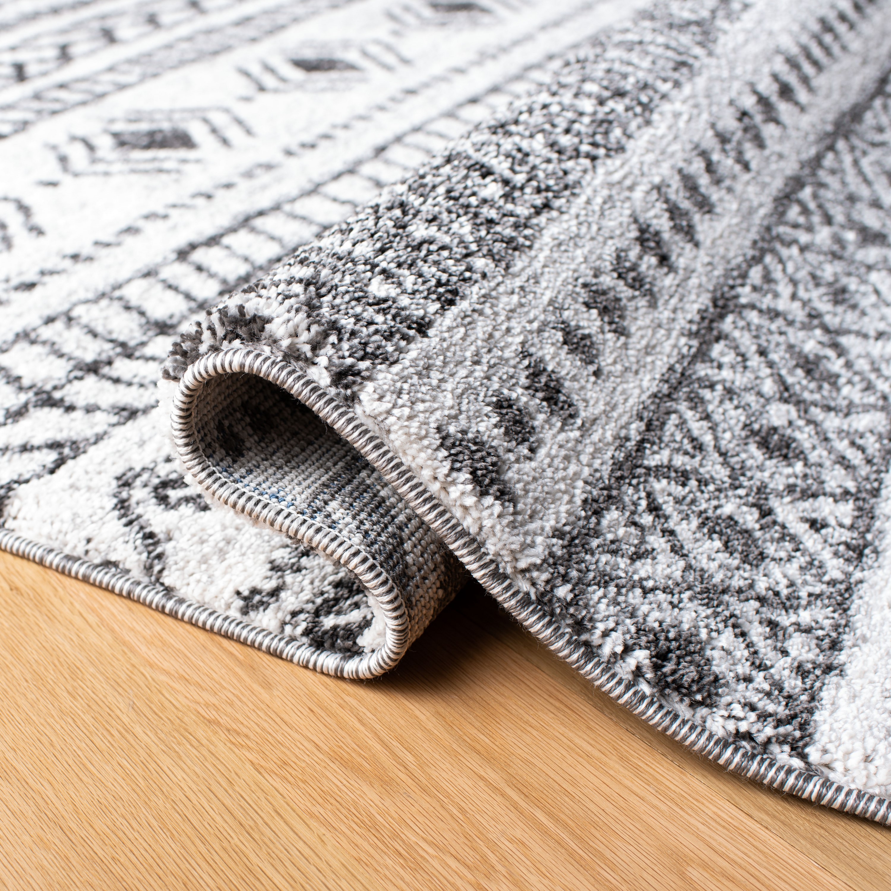 8' x 10' Black and Ivory Geometric Synthetic Area Rug