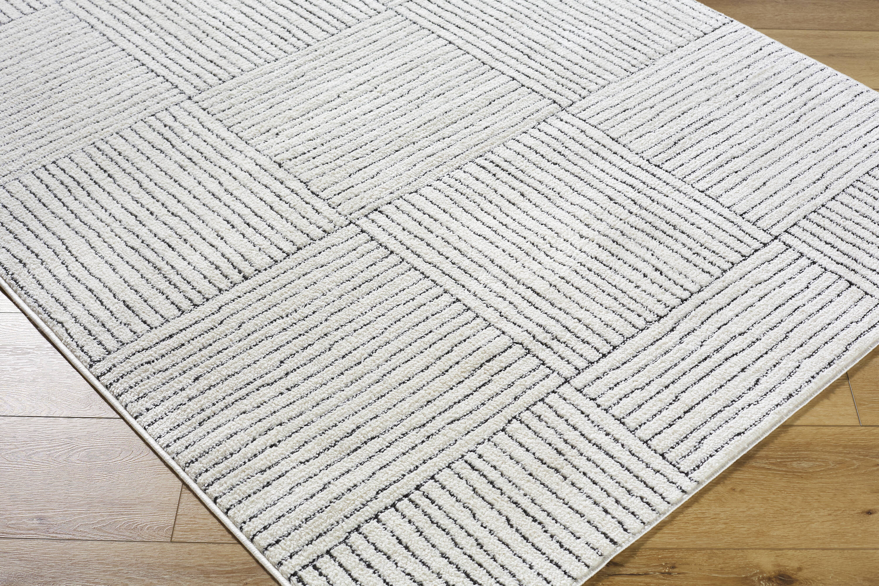 Ivory and Black Geometric Patterned Synthetic Area Rug, 5' x 7'