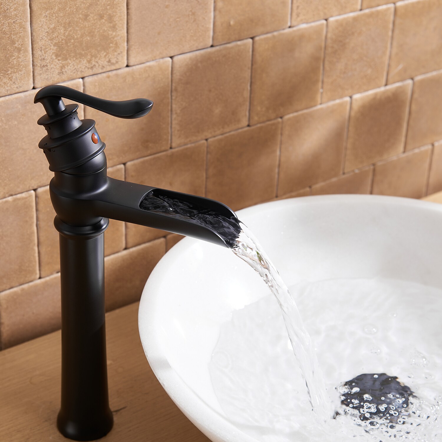 Waterfall vessel sink top faucet